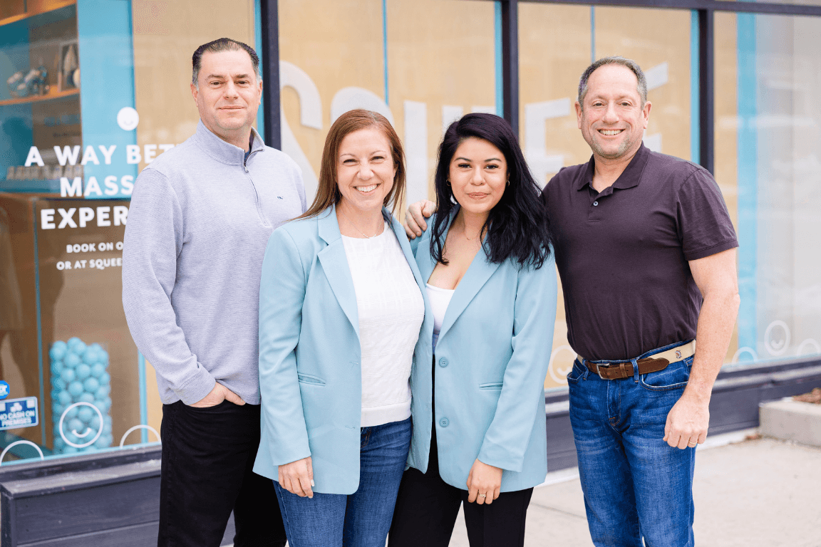 The Squeeze Massage leadership team outside a Squeeze shop